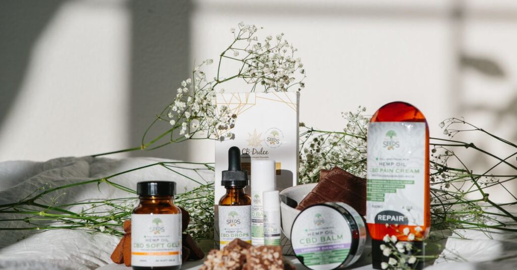 Best Products A collection of CBD and hemp products displayed with delicate floral accents in natural light.