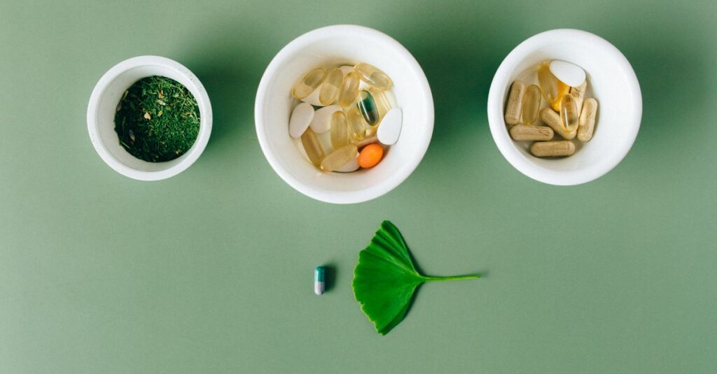 Best Products Flatlay of capsules and herbs in ceramic bowls on green surface.