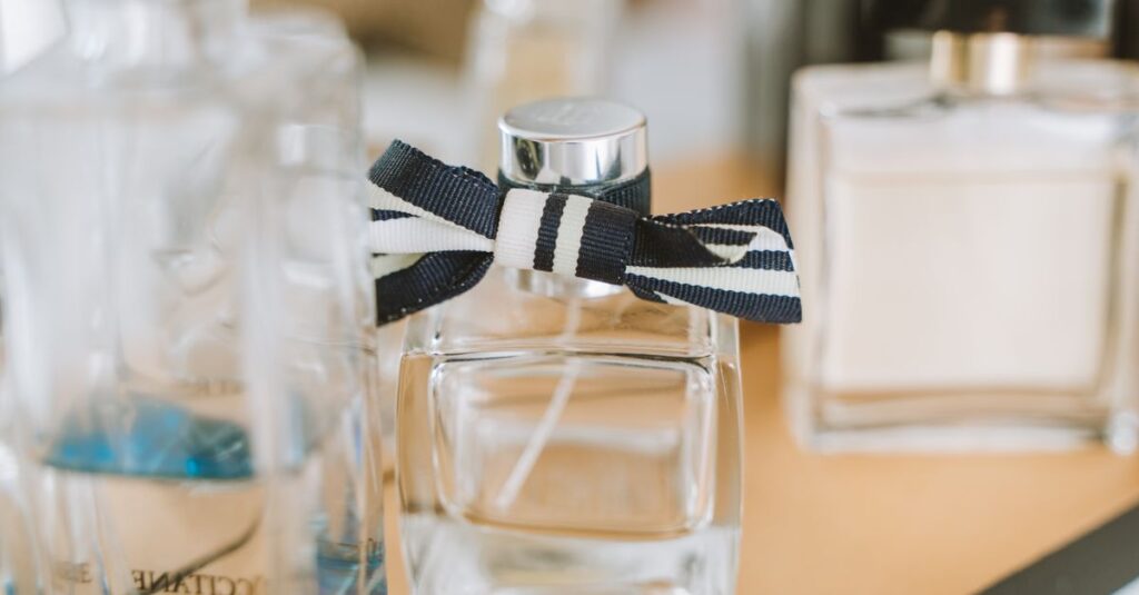 Close-up of elegant perfume bottles with focus on one with ribbon.