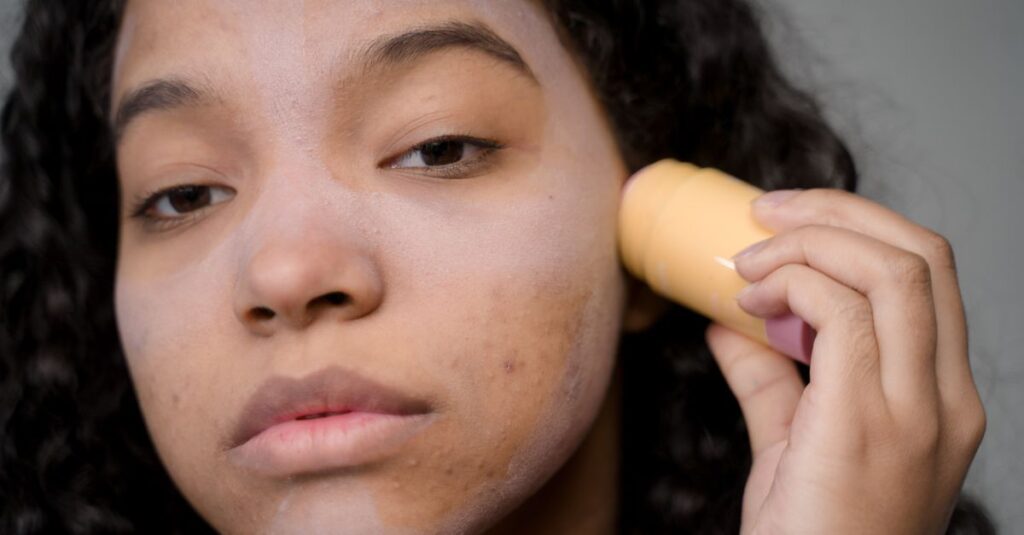 Skincare Close-up portrait of a woman applying skincare product to address acne and improve skin texture.